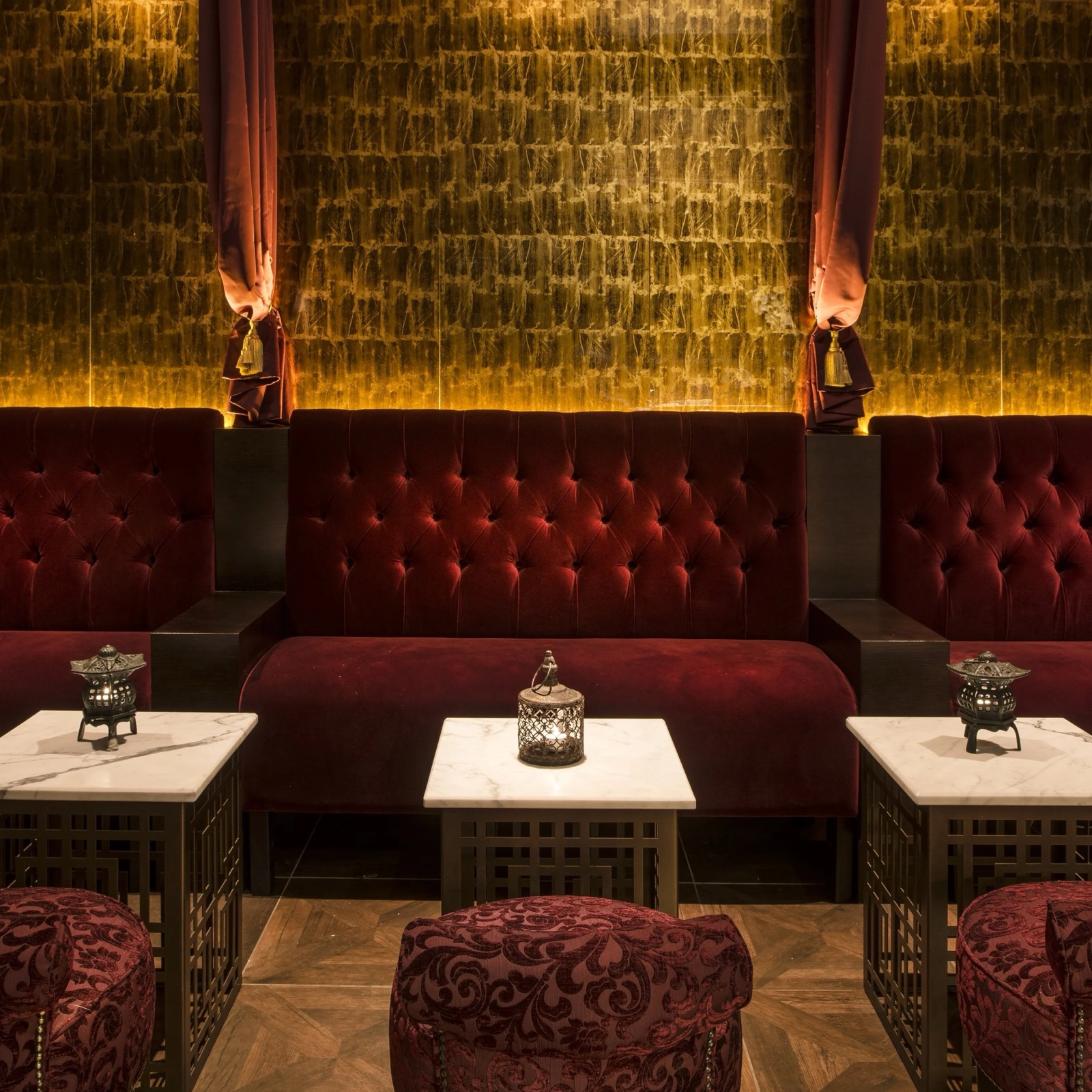 Velvet banquettes and lanterns in the Opium Den